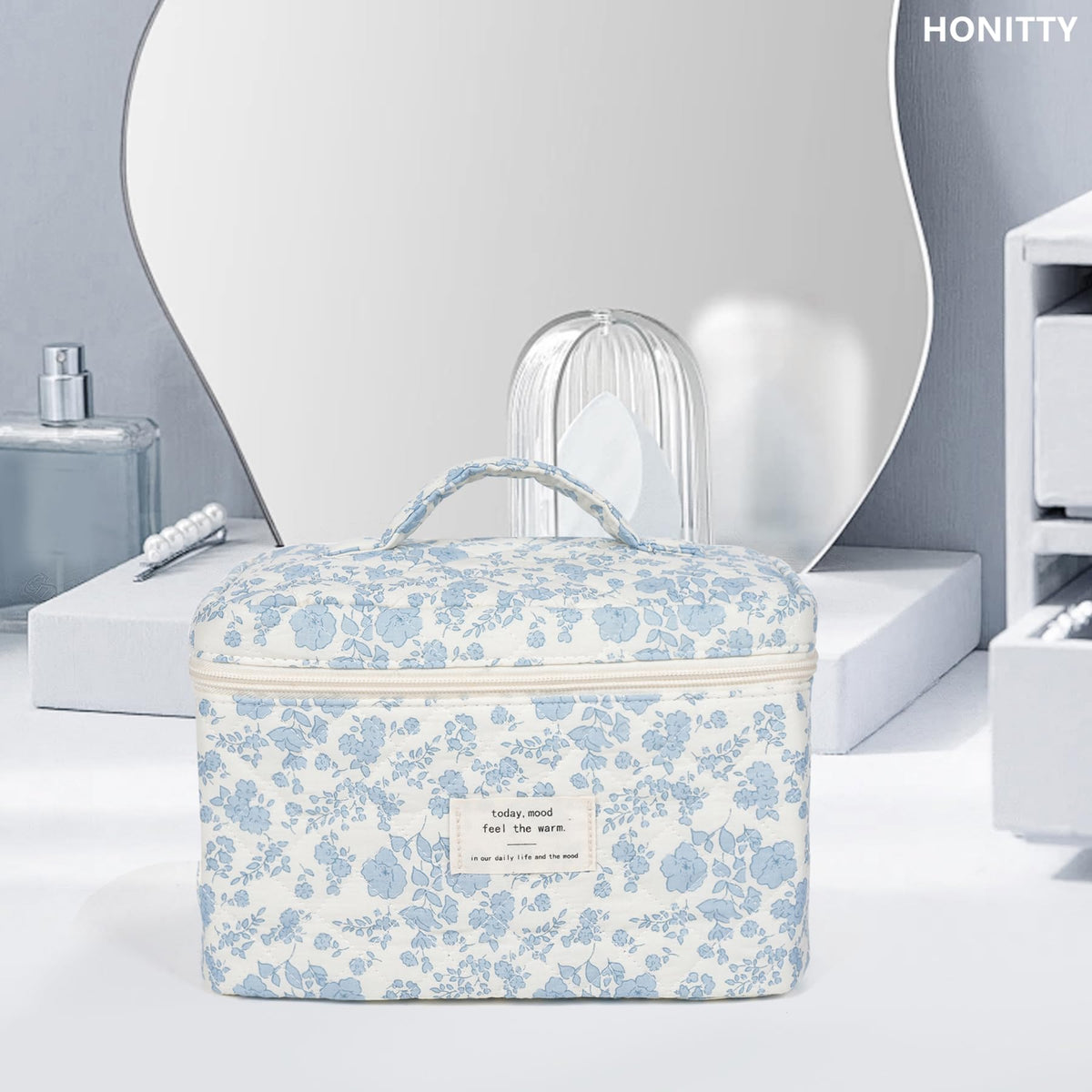 honitty Floral Makeup Bag on a dresser with cosmetics
