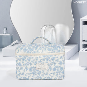 honitty Floral Makeup Bag on a dresser with cosmetics