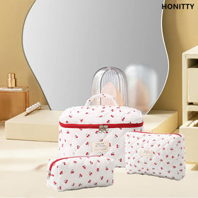 honitty makeup bag set on a dresser with cosmetics