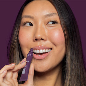 I.T.K. Nourishing Lip Balm displayed with natural ingredients