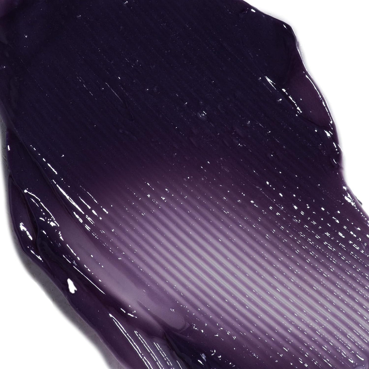 IGK Pitch Black Hair Gloss being applied to hair