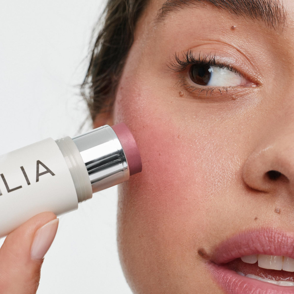 ILIA Multi-Stick Cheek + Lip Color At Last Mauve Rose on model's cheeks
