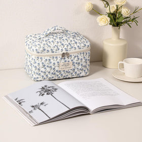 Inside view of uekeboag Large Travel Quilted Makeup Bag with makeup items