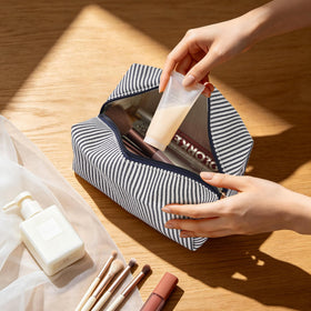Inside view of UUYUUY cosmetic pouch with makeup items
