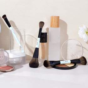 Jessup Face Makeup Brushes Set displayed with makeup products