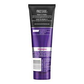 John Frieda Frizz Ease Beyond Smooth Shampoo with a background of coconut
