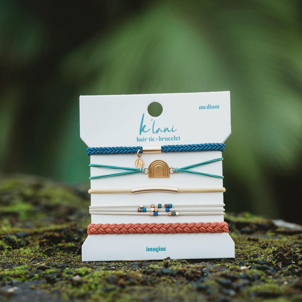 K'lani Imagine Hair Tie Bracelets packaging on a wooden surface