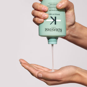 KÉRASTASE Specifique Balancing Shampoo on a vanity