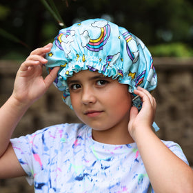 Kids Silk Sleep Bonnet on a bed pillow, showing hair protection