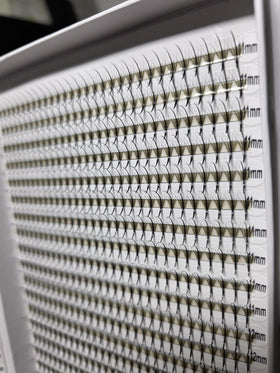 Kimeyelashes premade fans in a lash artist's setup