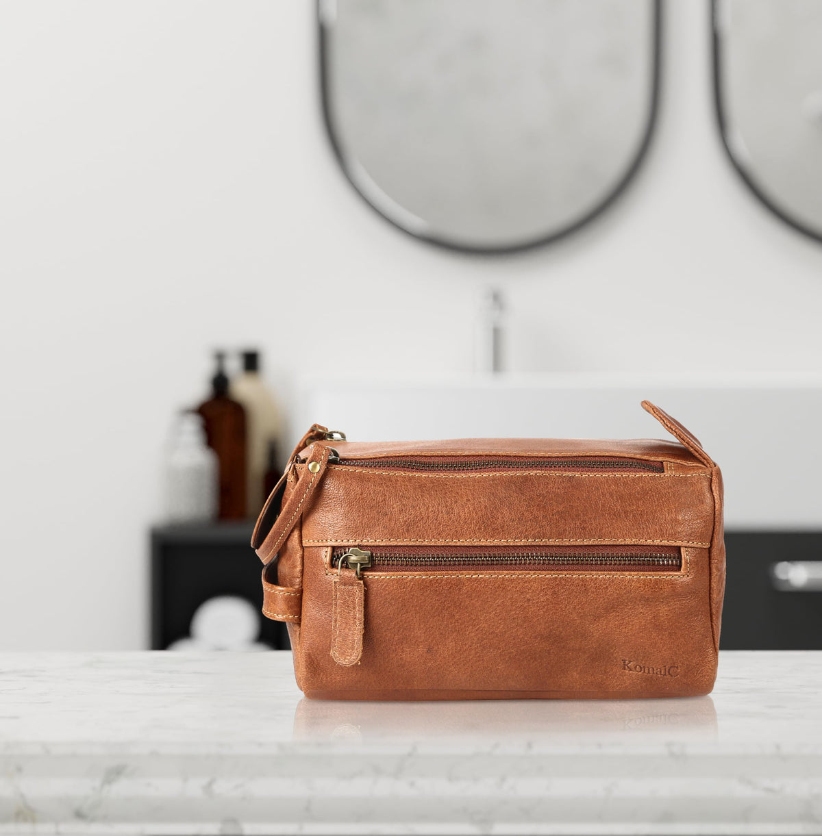 KomalC Toiletry Bag displayed on a bathroom counter
