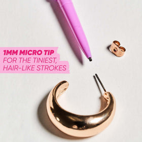Kosas Brow Pop Nano Dark Brown on a makeup table