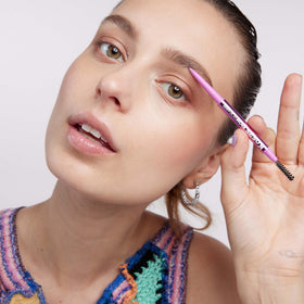 Kosas Brow Pop Nano Ultra-Fine Eyebrow Pencil in hand
