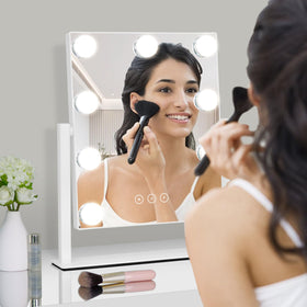 Kotdning Vanity Mirror with lights turned on in a makeup setup
