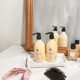 L LUSETA Perfect Bonding Shampoo and Conditioner on a bathroom shelf