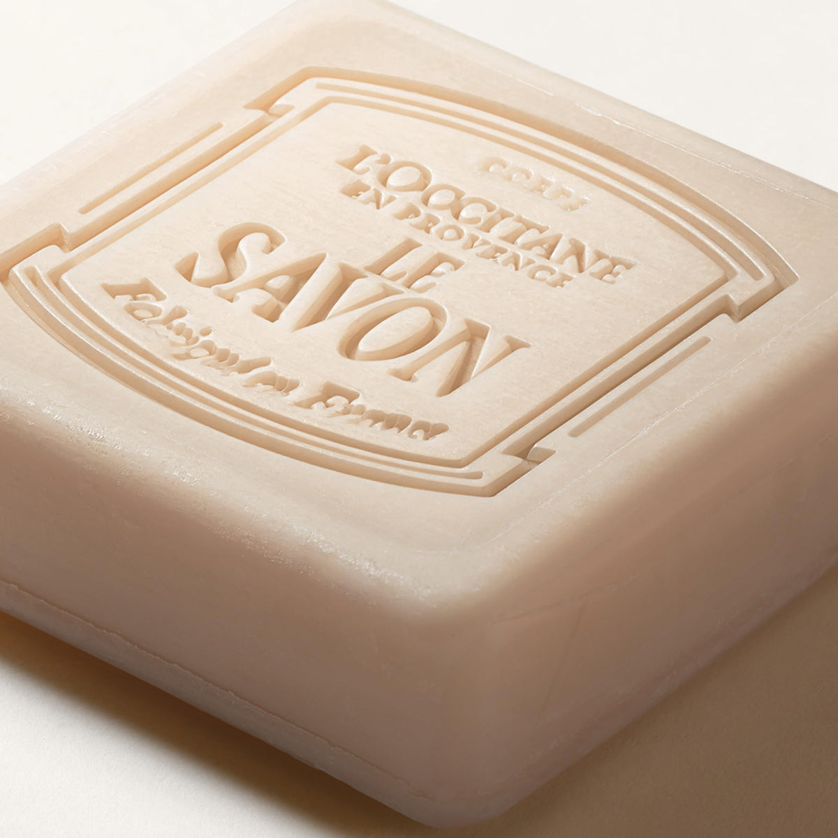 L'OCCITANE Shea Butter Soap Bar surrounded by flowers