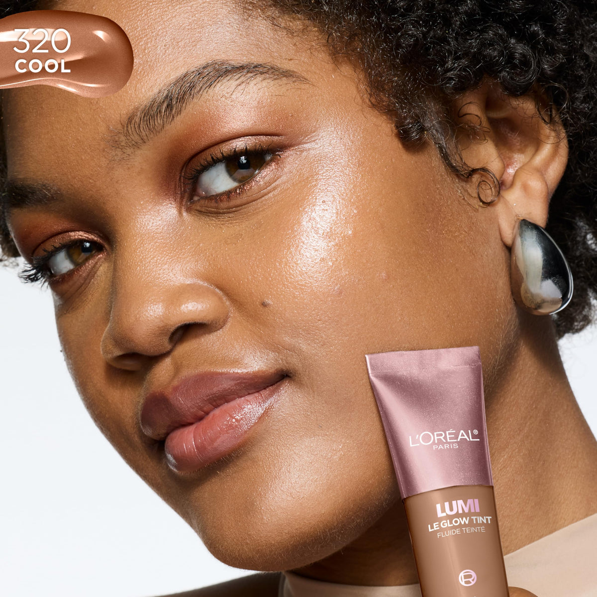 L'Oreal Paris Lumi Le Glow Skin Tint 320 on a makeup table
