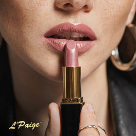 L'Paige Champagne Lipstick in a makeup bag alongside other cosmetics