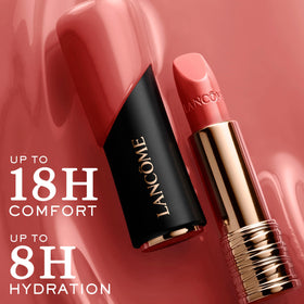Lancôme L'Absolu Rouge lipstick in hand with floral background