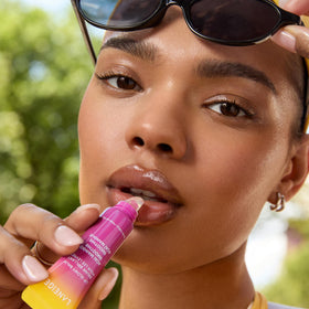LANEIGE Lip Glowy Balm Acai Mango on a flat surface