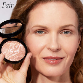 LAURA GELLER Baked Bronze-N-Brighten Bronzer Powder in hand