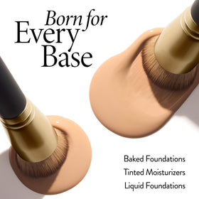 LAURA GELLER blending brush on a makeup table