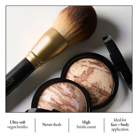 LAURA GELLER Classic Bronzer Brush applying bronzer to cheeks