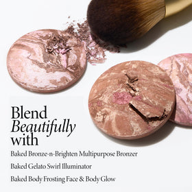 LAURA GELLER Classic Bronzer Brush on a vanity with makeup products
