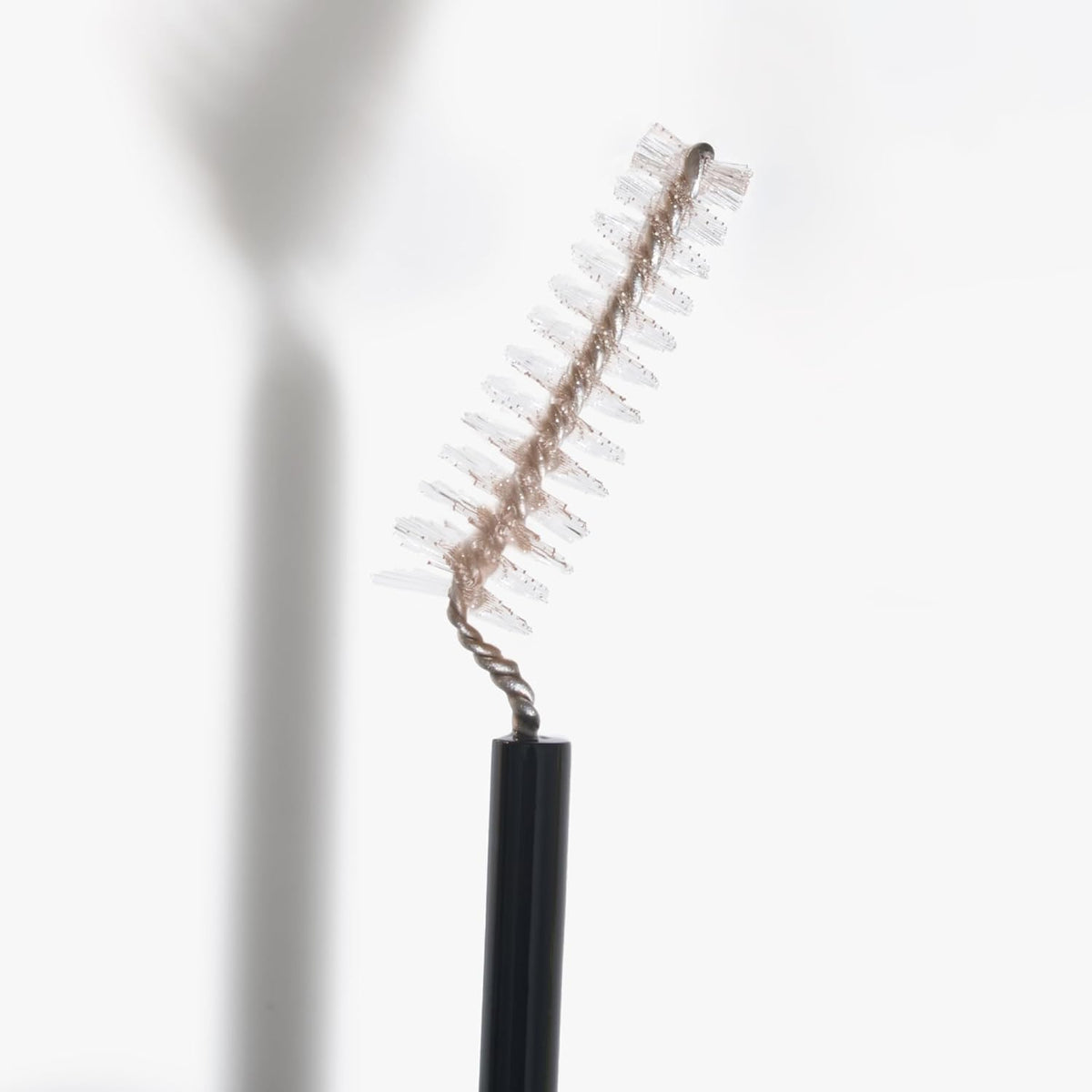 LAURA GELLER Sculpt-n-Stay eyebrow pencil on a makeup table