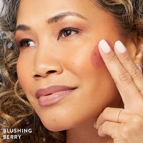 LAURA GELLER Serum Blush Tint Blushing Berry texture on hand