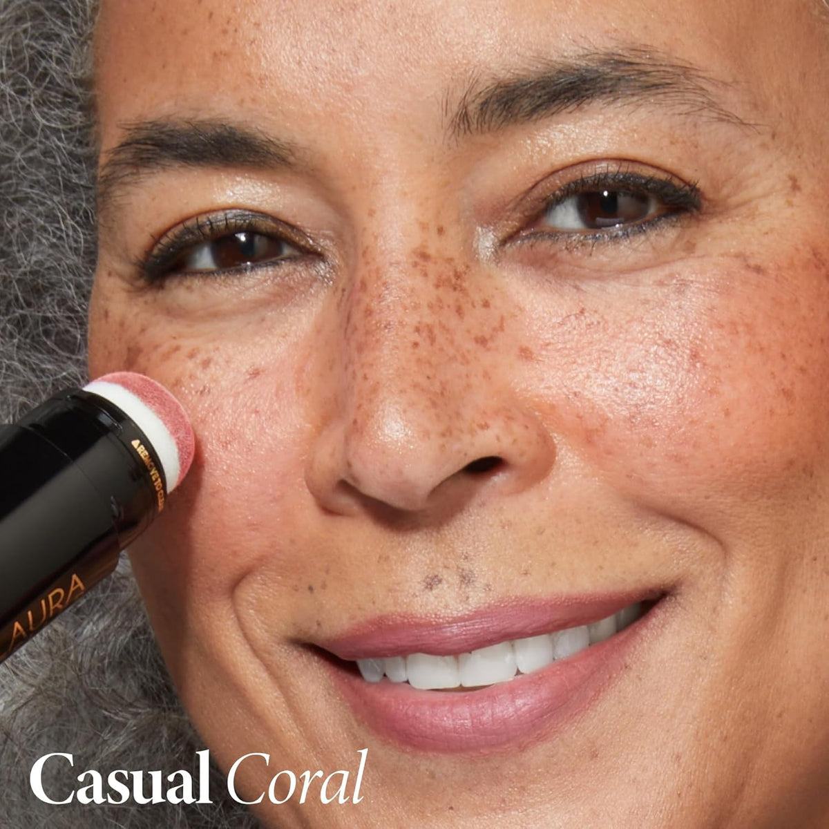 LAURA GELLER Serum Blush Tint Casual Coral texture on hand
