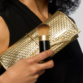 LAURA GELLER The Brush Vault brushes displayed in roll bag