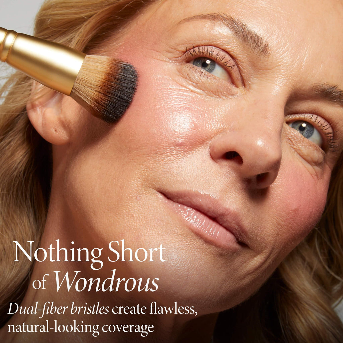 LAURA GELLER The Wonder Brush in use applying cream blush