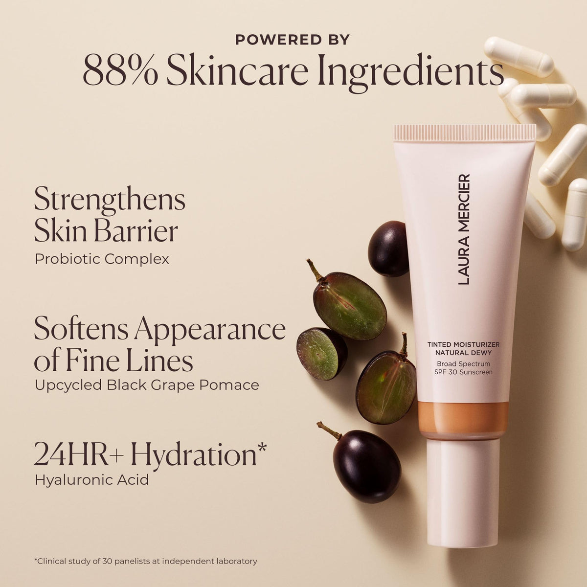 Laura Mercier Tinted Moisturizer displayed with makeup brushes