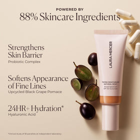 Laura Mercier Tinted Moisturizer displayed with makeup brushes