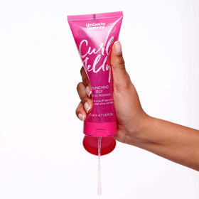 Lifestyle image of a woman applying hair cream