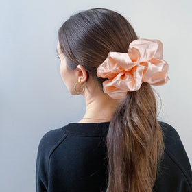 Lifestyle image of CEELGON scrunchies in use on a ponytail