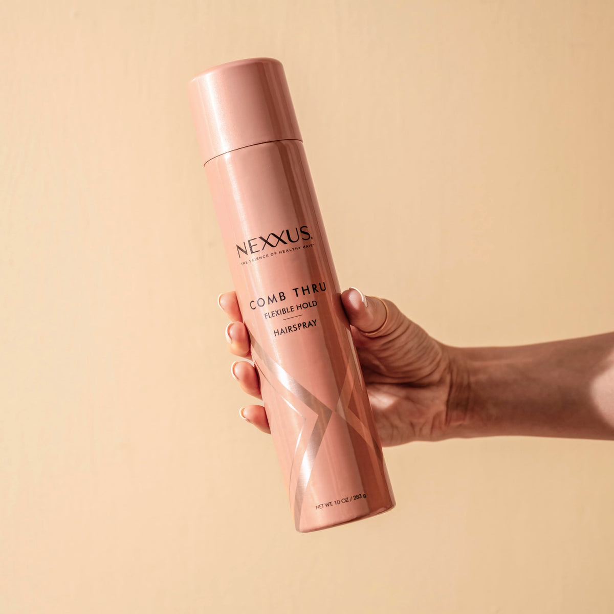 Lifestyle image of Nexxus Comb Thru Hairspray on vanity