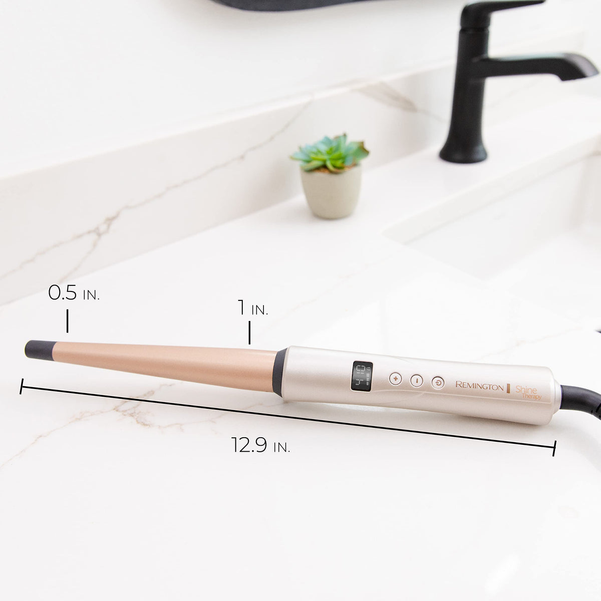 Lifestyle image of Remington Shine Therapy Tapered Curling Wand on vanity