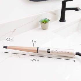Lifestyle image of Remington Shine Therapy Tapered Curling Wand on vanity