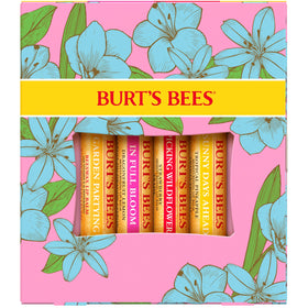 Lifestyle scene of Burt's Bees lip balm set on a wooden table