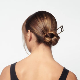 Lifestyle scene of ORIBE Superfine Hair Spray on a vanity