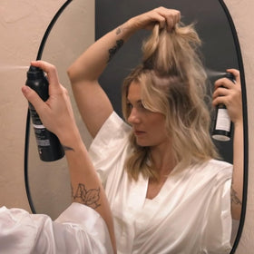 Lifestyle scene with Kristin Ess Dry Shampoo in a gym bag