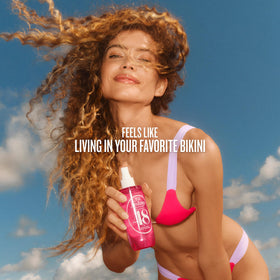 Lifestyle scene with Sol de Janeiro Cheirosa 48 mist on a beach