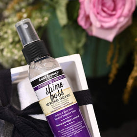 Lifestyle shot of a woman using Aunt Jackie's Shine Boss Mist