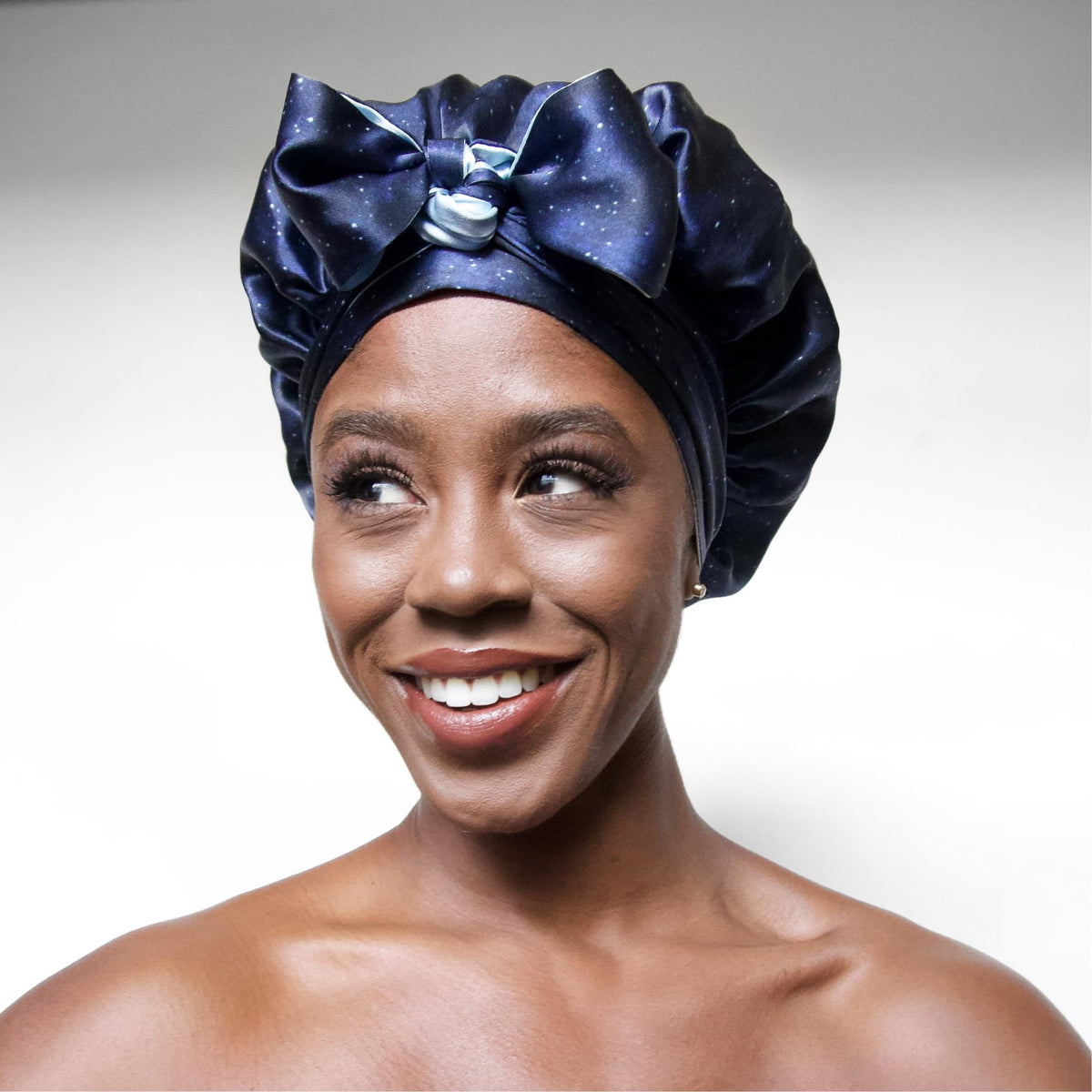 Lifestyle shot of a woman wearing Nochka Fashion silk bonnet