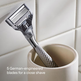 Lifestyle shot of Harry's razor in use during shaving