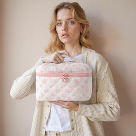 Lifestyle shot of HBselect makeup bags in a travel setting