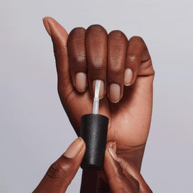 Lifestyle shot of OPI Chip Skip Primer with manicure tools
