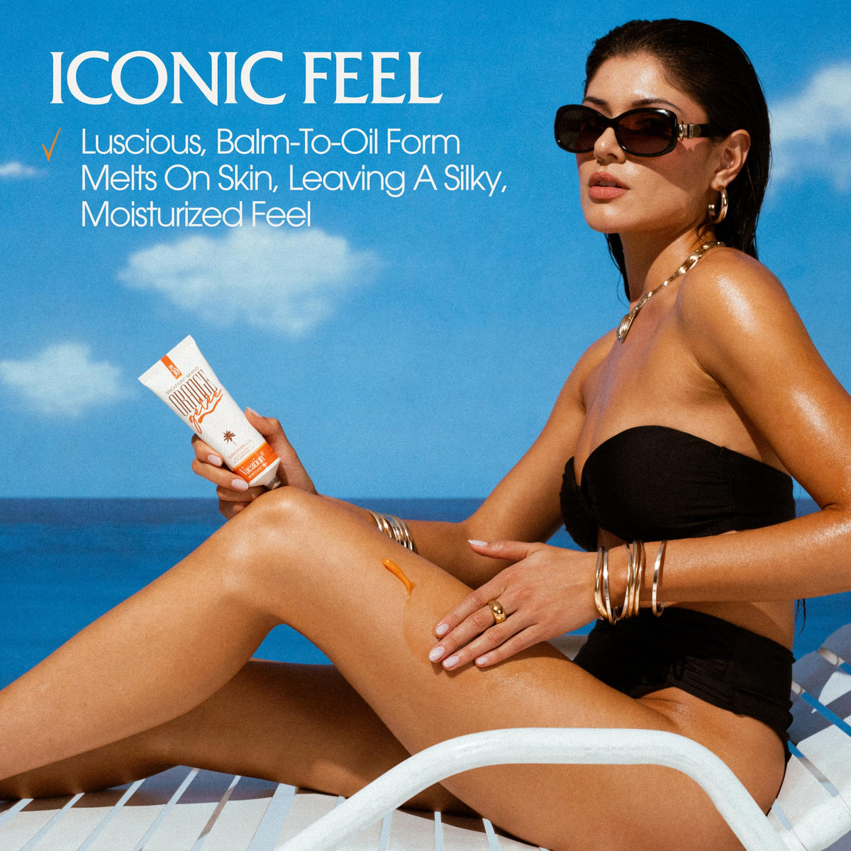 Lifestyle shot of VACATION Orange Gelée SPF 30 Sunscreen Gel on beach towel
